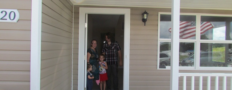 Homeowners standing in doorway of new home