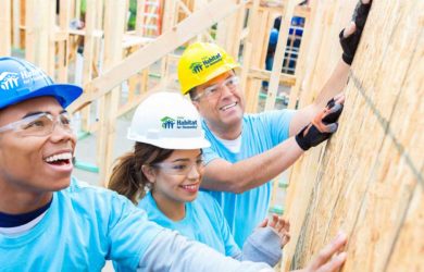 Smiling workers working on a Habitat Home.