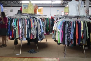 Round racks of donated women's clothing in the apparel section of the Habitat ReStore Sebring