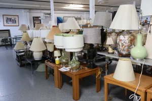 Rows of table lamps with shades displayed for sale in the Habitat ReStore Sebring lighting section